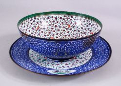 A 19TH CENTURY PERSIAN ENAMEL BOWL AND DISH, the bowl with a white interior with bird and flora