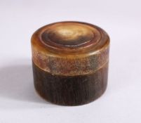 A 19TH CARVED RHINOCEROS HORN TURNED LIDDED BOX, 4.5cm.