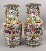 A PAIR OF 19TH CENTURY CHINESE CANTON FAMILLE ROSE PORCELAIN VASES, the white ground with panel
