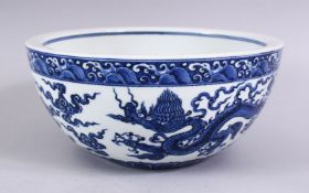 A LARGE CHINESE MING STYLE BLUE & WHITE DRAGON PORCELAIN BOWL, the bowl decorated interior with a