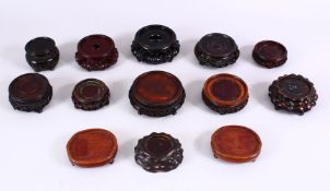 A MIXED LOT OF 13 19TH CENTURY CHINESE CARVED HARDWOOD STANDS, of varying size and style, largest
