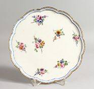 A SEVRES PEDESTAL TAZZA painted with flowers under a single blue line and dentil gilding,