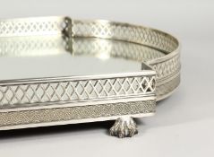 A GOOD BOW ENDED TABLE CENTREPIECE, with mirrored panel, pierced sides, on claw feet. 22ins long x