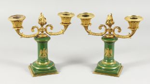 A GOOD PAIR OF LOUIS XVI PORCELAIN AND ORMOLU TWO-LIGHT CANDLESTICKS, the stems with winged eagles