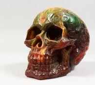 A RESIN MODEL OF A HUMAN SKULL. 7ins long.