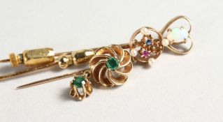 THREE DECORATIVE GOLD STICK PINS.