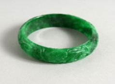 AN APPLE GREEN JADE BANGLE. 3ins diameter.