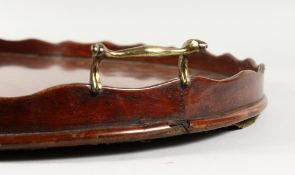 A GOOD GEORGIAN MAHOGANY OVAL TWO-HANDLED TRAY with brass waved rim. 26ins long.