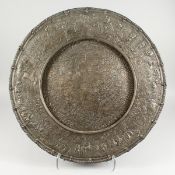 A CONTINENTAL WHITE METAL CIRCULAR CHARGER, with inscription dated 1575, depicting a town, many