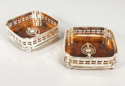 A PAIR OF SILVER PLATE AND FAUX TORTOISESHELL COASTERS. 5ins wide.