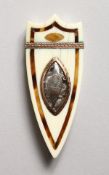 A GEORGE III SHIELD SHAPED IVORY AND TORTOISESHELL PATCH BOX, the lid with silver cartouche,