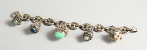 A FILIGREE SILVER CHARM BRACELET.