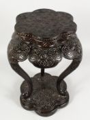 A TIN LACQUERED STAND on three curving legs and shaped bases.