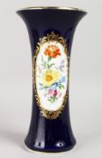 A GOOD 19TH CENTURY MEISSEN RICH BLUE TRUMPET VASE, painted with an oval panel of flowers. Cross