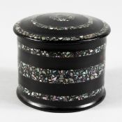 A PAPIER MACHE AND MOTHER-OF-PEARL CIRCULAR BOX AND COVER. 3ins diameter.