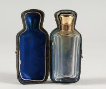 A CUT GLASS SCENT BOTTLE with 18ct gold top, in a fitted case.
