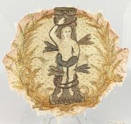 A 17TH CENTURY STUMPWORK TYPE TEXTILE FRAGMENT of ADAM. Stuck on to a piece of glass which is AF.