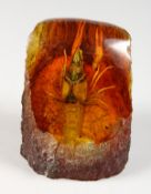AN AMBER STYLE PAPERWEIGHT INSET WITH A CRAYFISH. 3.5ins high.