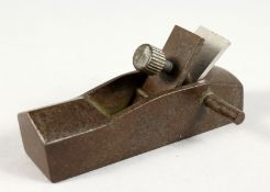 A SMALL BRONZE MODEL OF A WOODWORKING PLANE. 3.5ins long.
