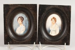 A PAIR OF OVAL PORTRAIT MINIATURES in wooden frames. 3ins x 2ins. Monogrammed.