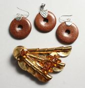 A SILVER GILT ART DECO STYLE BROOCH; together with A SILVER AND GOLD STONE PENDANT with matching