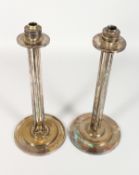 A PAIR OF ART DECO STYLE COLUMN SHAPE CANDLESTICKS on circular bases. 14.5ins high.