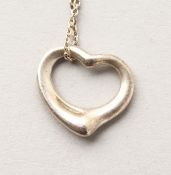 A TIFFANY HEART AND CHAIN in a Tiffany pouch.