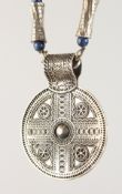 AN ISLAMIC SILVER CHAIN with circular pendant.