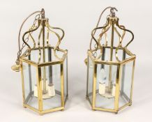 A PAIR OF BRASS HEXAGONAL SHAPED HALL LANTERNS. 17.5ins high.