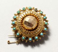A GOLD AND TURQUOISE BROOCH.