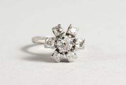 A SUPERB 18CT WHITE GOLD, DIAMOND FLOWER HEAD CLUSTER RING, a central diamond surrounded by six