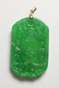 AN APPLE GREEN JADE PENDANT. 2.25ins diameter.