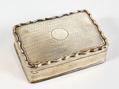 A RECTANGULAR SILVER BOX with engine turned top. 3ins long. London 1906.