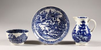 A WILLOW PATTERN BLUE AND WHITE TEA BOWL AND SAUCER, unusual mark, and A SPARROW BEAK JUG. (3)