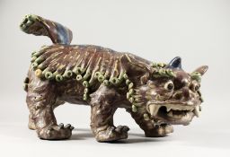 A LARGE ORIENTAL CERAMIC SHI DOG. 19ins long.