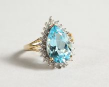 A 9CT GOLD PEAR SHAPED BLUE TOPAZ AND DIAMOND RING.