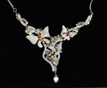 A LOVELY SILVER BUTTERFLY NECKLACE inset with tourmalines.