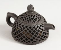 A CHINESE PIERCED POTTERY TEAPOT.