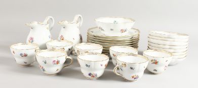 A GOOD MEISSEN PART TEA SET, sprigged with flowers, comprising eight plates, two milk jugs, eight