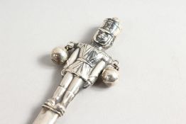 A SILVER NOVELTY RATTLE.