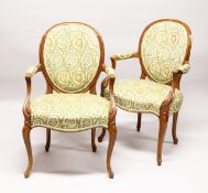 A GOOD PAIR OF FRENCH BEECH WOOD ARMCHAIRS with padded back and seats.
