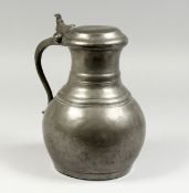 A LARGE FRENCH PEWTER JUG AND COVER.