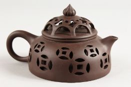 A CHINESE PIERCED POTTERY TEAPOT.