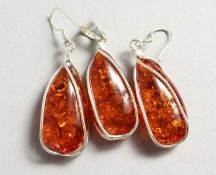 A SILVER AND AMBER PENDANT with a pair of matching earrings.