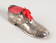 A SILVER SHOE PIN CUSHION.