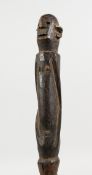 A CARVED TRIBAL HOUSE MARKER. 13.5ins long.