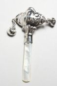 A SMALL SILVER RATTLE WITH MOTHER-OF-PEARL HANDLE. 3.25ins long.