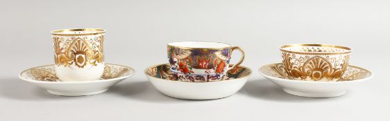 A SPODE COFFEE CUP AND SAUCER AND A TEACUP AND SAUCER superbly decorated in raised gold in Empire