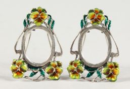 A PAIR OF MINIATURE SILVER AND ENAMEL PHOTO FRAMES.