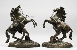 A GOOD PAIR OF 19TH CENTURY FRENCH BRONZE MARLEY HORSES AND ATTENDANTS after COUSTOU. Signed. 15.